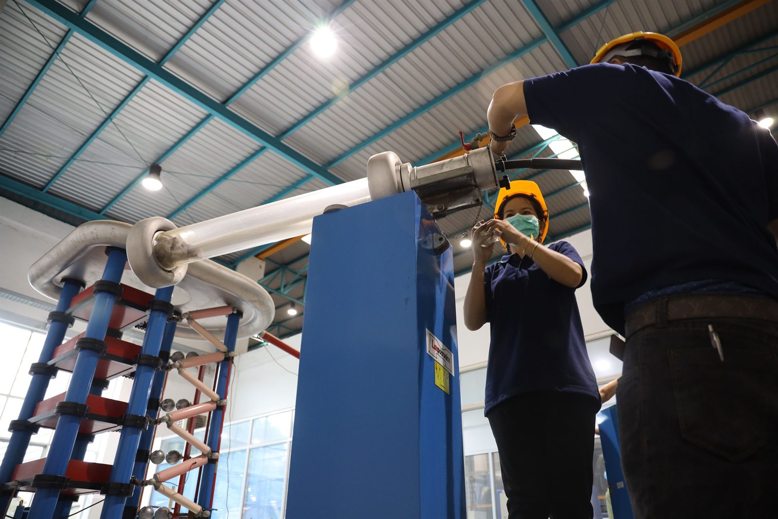 Engineers operating the high voltage test rig